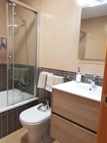 a bathroom with a toilet and a sink and a shower at Apartments Sol de Almeria Golf y Playa in Retamar