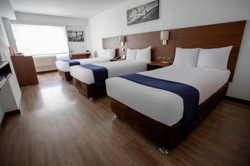 a hotel room with two beds and a window at Casa Andina Select Miraflores in Lima