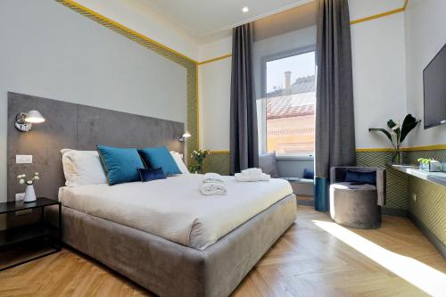 a bedroom with a large bed and a large window at Roma Five Suites in Rome