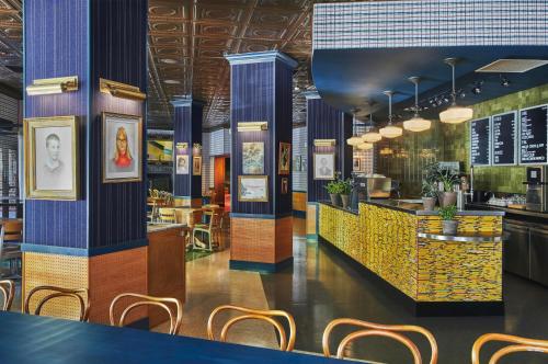 een restaurant met blauwe en gele pilaren en stoelen bij Graduate Providence in Providence