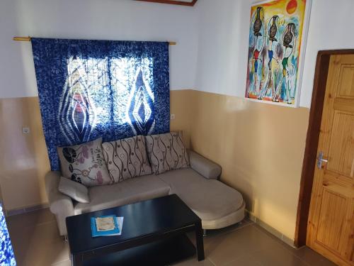 a living room with a couch and a table at Kunta Kinteh Beach Complex in Kotu