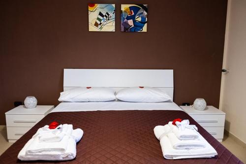 a bedroom with a bed with white shoes on it at ALMI B&B in Sarno