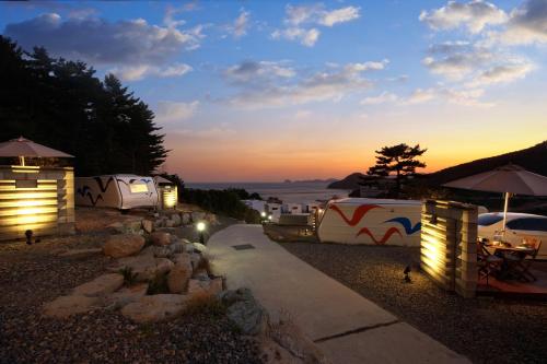 a group of tents and a path with lights at Tropical Dream Spa Caravan in Geoje