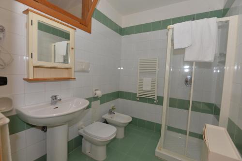 a bathroom with a sink and a toilet and a shower at Miramare Residence in Pozzuoli