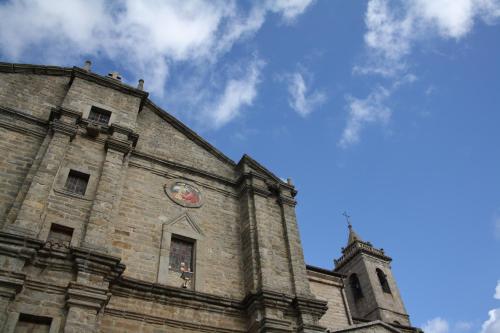a building with a clock on the side of it at Pausania Inn in Tempio Pausania
