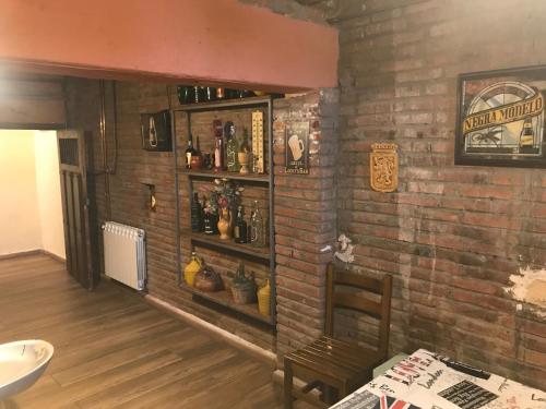 a room with a brick wall with a shelf at Casa LEON in León