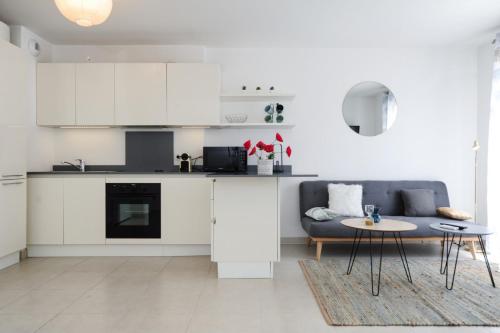 - une cuisine blanche avec un canapé et une table dans l'établissement Mini suite Othello - Five Stars Holiday House, à Nice