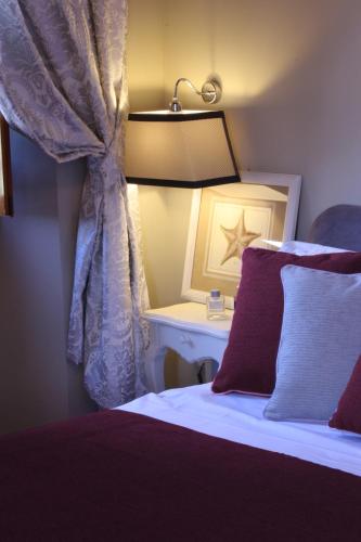 a bedroom with a bed and a table with a lamp at Hotel Villa Cappugi in Pistoia