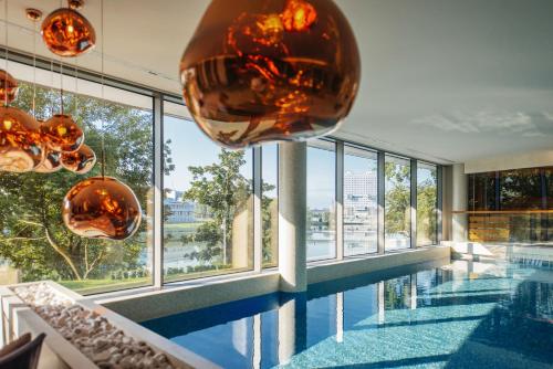 a building with a pool and large glass windows at Crystal House Suite Hotel & SPA in Kaliningrad