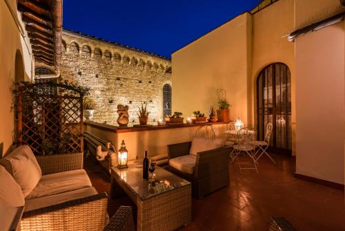 an outdoor patio with a couch and chairs and a table at B&B San Remigio in Florence
