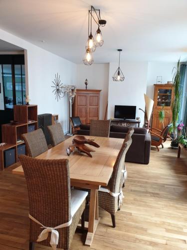 a dining room with a wooden table and chairs at Brest quartier Siam appartement 3 étoiles in Brest