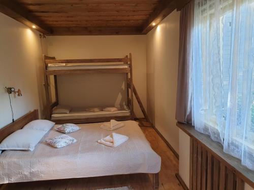 a small bedroom with a bunk bed and a window at Guest House and camping Jurmala in Jūrmala