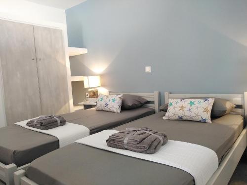 a bedroom with two beds with towels on them at STELLA MARINA in Panteli