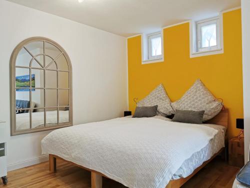 a bedroom with a bed and a window at Allgäu Apartment Kempten in Kempten