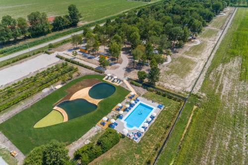an aerial view of a resort with a pool at Agriturismo Tenuta Regina - Glamping luxury lodges and apartments in Palazzolo dello Stella