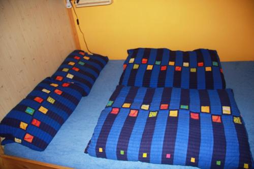 a bed with two blue sheets with legos on it at Penzion W in Plzeň