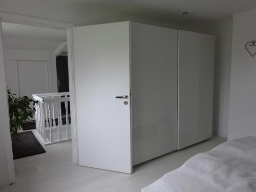 a white closet in a bedroom next to a bed at Ferienhaus mit Kamin in Xanten