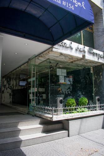 a store front of a building with a blue umbrella at Hotel Del Angel Reforma in Mexico City