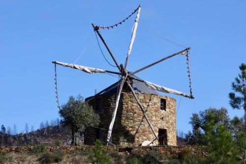 an old stone windmill on top of a hill at Moinho da Fadagosa in Mação