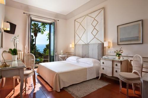 En eller flere senger på et rom på Hotel Villa Belvedere