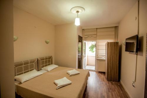 a bedroom with a bed with two towels on it at Hotel Cappa in Ürgüp