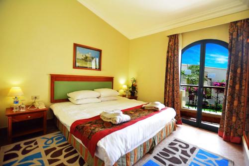 a bedroom with a bed with two towels on it at Island View Resort in Sharm El Sheikh