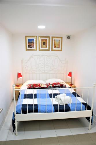 a bedroom with a white bed and two lamps at Alfama 34 in Lisbon