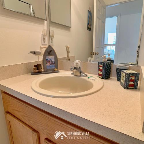a bathroom counter with a sink and a mirror at Affordable Luxury Home Near Walt Disney World - Sunshine Villa at Glenbrook Resort, Orlando, Florida in Orlando