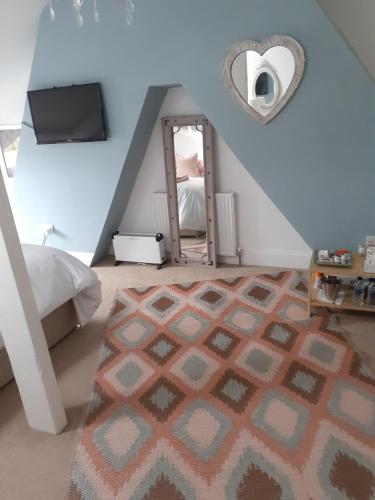 a bedroom with a staircase with a mirror and a rug at The Bridges B&B in Broomhill