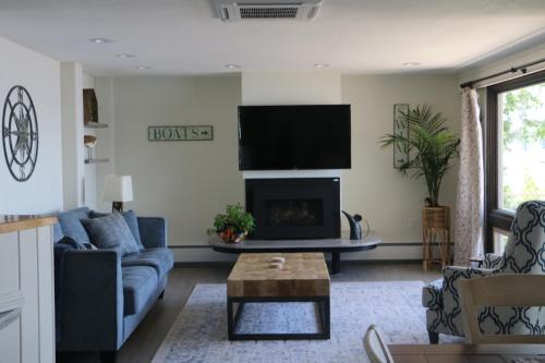 a living room with a couch and a fireplace at Lakeshore Vermont in Colchester
