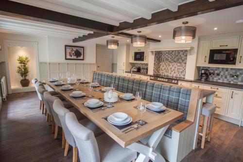a large dining room with a long table and chairs at High Oaks Grange - Cottages in Pickering