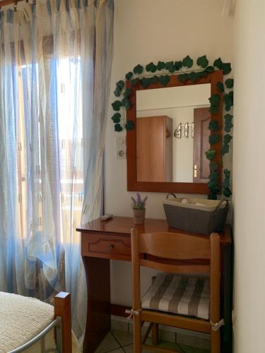 a bathroom with a vanity with a mirror and a sink at Ifigenia Apartments in Ermoupoli