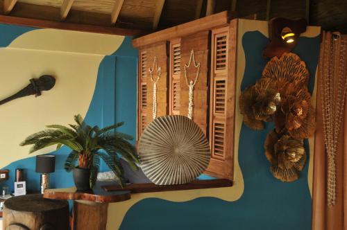 a room with a fan on a wall at Mango Island Lodges in Saint Joseph