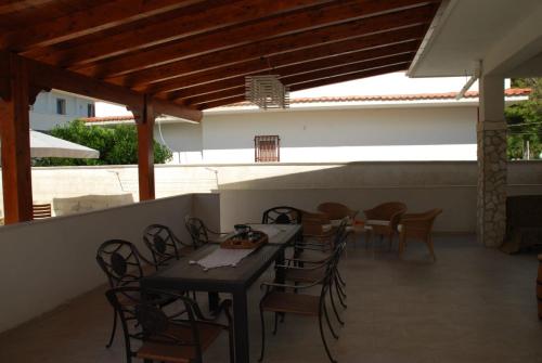 a patio with a table and chairs on a roof at Villa Cohiba - 700m dal mare in Pulsano