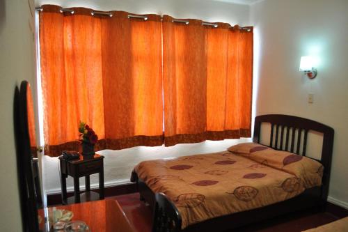 Una cama o camas en una habitación de Hotel 5a Avenida