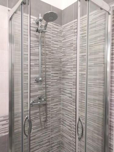 a shower with a glass door in a bathroom at La Bussola in Porto Cesareo