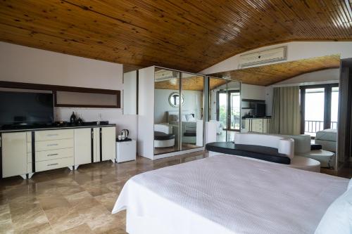 a bedroom with a bed and a living room at Palm Beach Şile Villa Hotels in Istanbul
