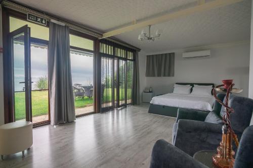 a bedroom with a bed and sliding glass doors at Palm Beach Şile Villa Hotels in Istanbul