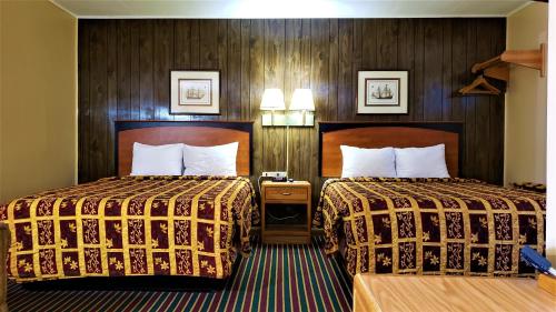 Ένα ή περισσότερα κρεβάτια σε δωμάτιο στο Grand Motel