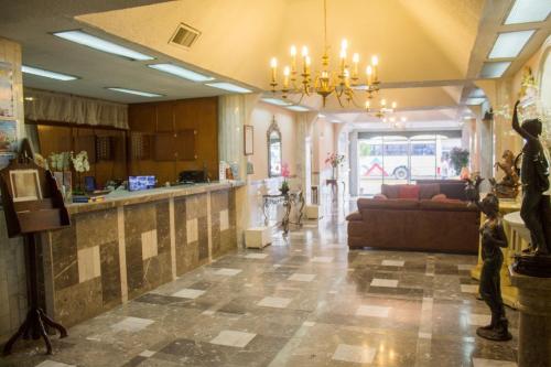 a large living room with a couch and a table at Hotel San Jorge in Tepic