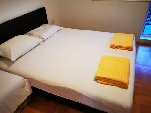 a large white bed with two towels on it at CENTRAL PARK SOKOBANJA in Soko Banja