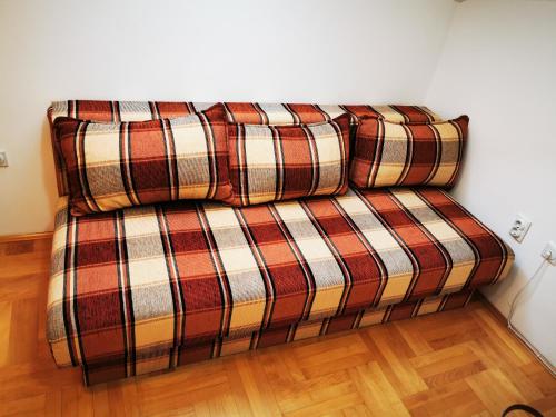 a couch with two pillows on it in a room at CENTRAL PARK SOKOBANJA in Soko Banja