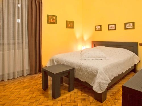 a bedroom with a bed and a table in it at Casa Vacanza Brasov in Braşov