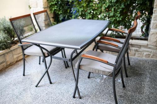 a black table and chairs on a patio at Apartments ANA Karlobag in Karlobag