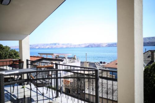 a balcony with a view of the water at Apartments ANA Karlobag in Karlobag
