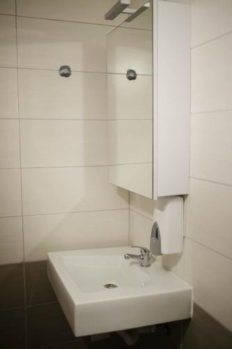 a bathroom with a white sink and a mirror at Apartments ANA Karlobag in Karlobag