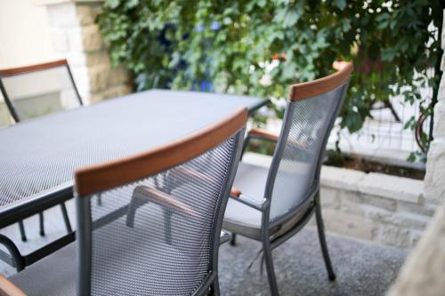 a table and two chairs sitting at a table at Apartments ANA Karlobag in Karlobag