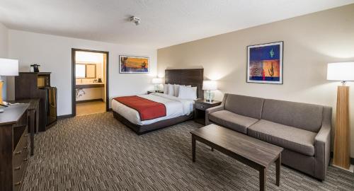a hotel room with a bed and a couch at Lux Verde Hotel in Cottonwood
