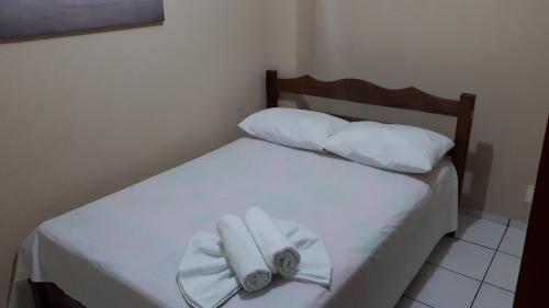 a bedroom with two white towels on a bed at Pousada da Orla in Salinópolis