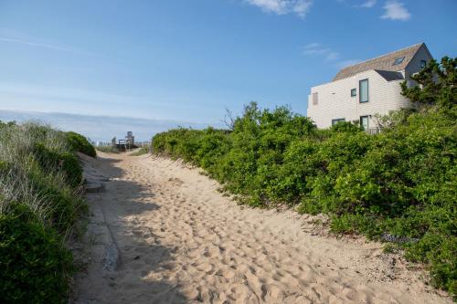 a dirt road leading to a house on the beach at The Ocean Resort Inn in Montauk
